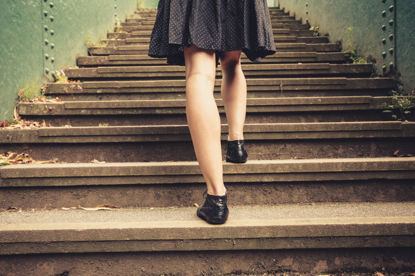 Young woman walking up stairs