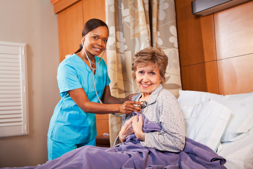 Nurse examining senior woman in hospital room